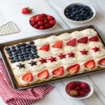 Vanilla quarter sheet cake decorated as an American flag with strawberries and blueberries