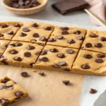 Close-up of sliced cookie dough protein bars with chocolate chips on top, soft texture