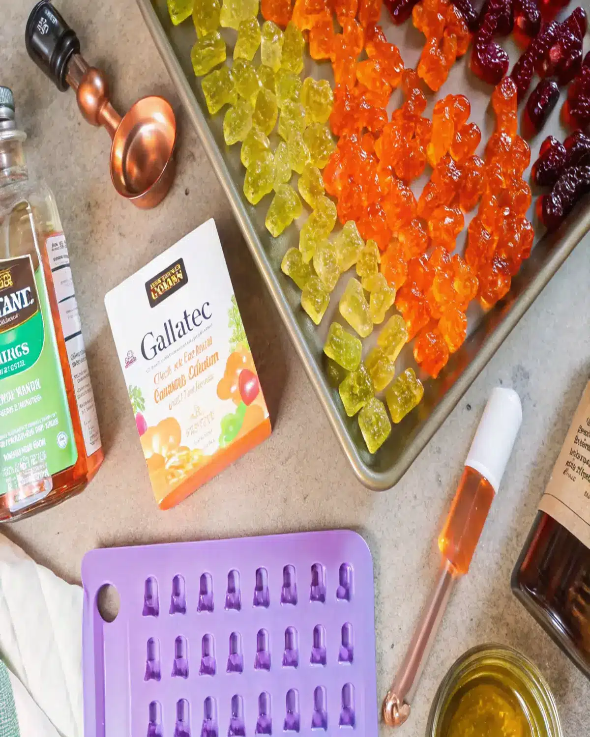 healthy-jelly-sweets-homemade-ingredients Flat lay of ingredients for making healthy jelly sweets at home, including gelatin, honey, and gummy molds